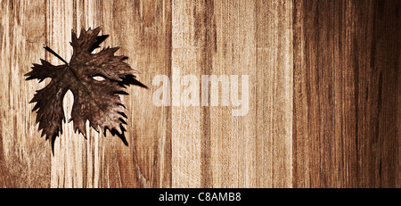 Autumn leaf border over natural wood background, old dry leaf shape, nature at fall Stock Photo