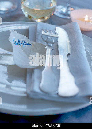 Guest's name at table written on a white leaf Stock Photo