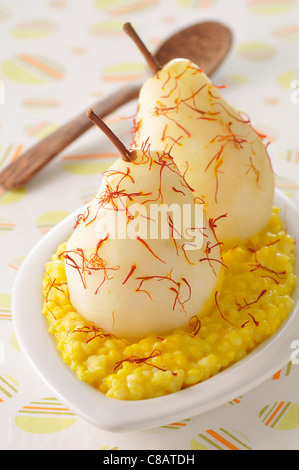 Saffron-flavored rice pudding with stewed pears Stock Photo