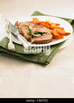 Rolled roast pork with herbs ,fried sweet potatoes Stock Photo