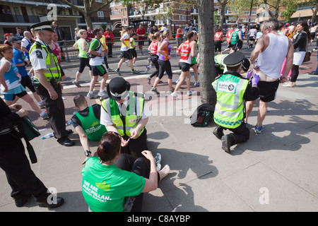 England, London, London Marathon, St.John Ambulance Staff Treating Injured Runners Stock Photo