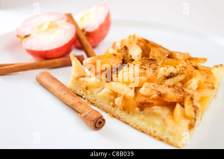 apple pie with cinnamon on a white plate. Stock Photo