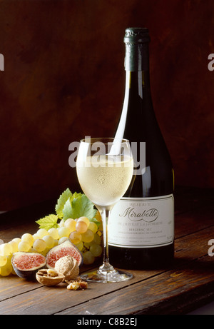 grapes, figs, plums and bottle of dry white Bergerac Jaubertie wine Stock Photo