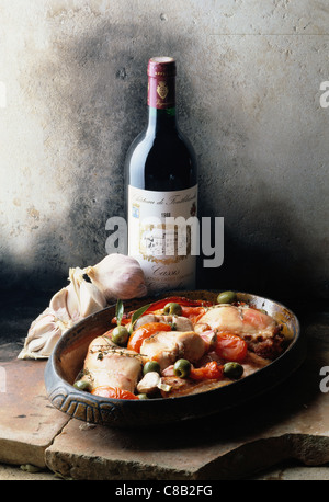 Provençal-style rabbit with bottle of red wine Stock Photo