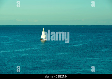 Sailboat on a calm sea off the tip of Grouin, near Cancale (Brittany, France). Stock Photo