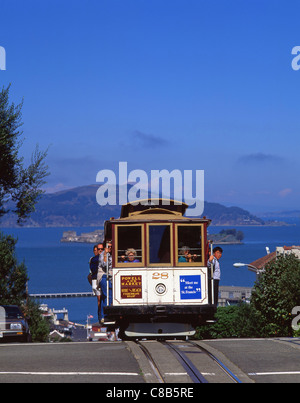 Cable car on Hyde Street with Alcatraz Island in background, San Francisco, California, United States of America Stock Photo