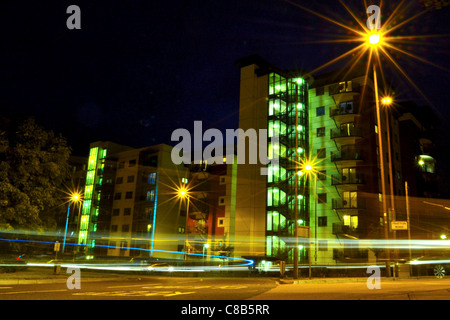 Long exposure photograph, taken from a low angle to create a colourful, dynamic and slightly abstract urban night-scape Stock Photo