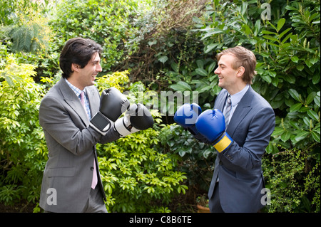 Two young men in suits stage a mock boxing match Stock Photo