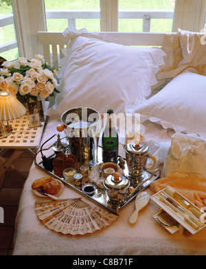 champagne in bed in hotel room Stock Photo