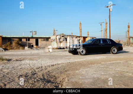 Rolls Royce parked in front of abandoned houses Stock Photo