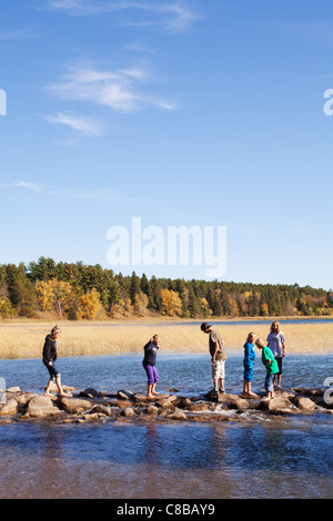 Youngsters cross the headwaters of the Mississippi River on Lake Itasca in Northern Minnesota. Stock Photo