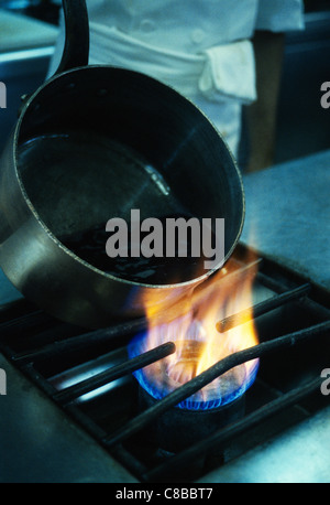 pan on stove flame Stock Photo