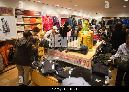 Customers shop at the grand opening of the Uniqlo Flagship store on Fifth Avenue in New York Stock Photo