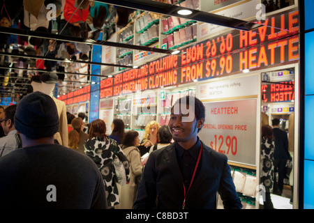 Customers shop at the grand opening of the Uniqlo Flagship store on Fifth Avenue in New York Stock Photo