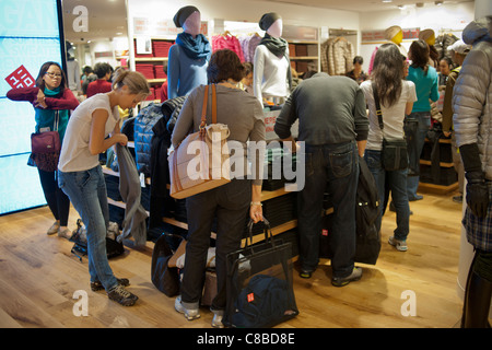 Customers shop at the grand opening of the Uniqlo Flagship store on Fifth Avenue in New York Stock Photo