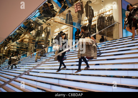 Customers shop at the grand opening of the Uniqlo Flagship store on Fifth Avenue in New York Stock Photo