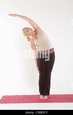 Mature woman doing stretching exercise Stock Photo
