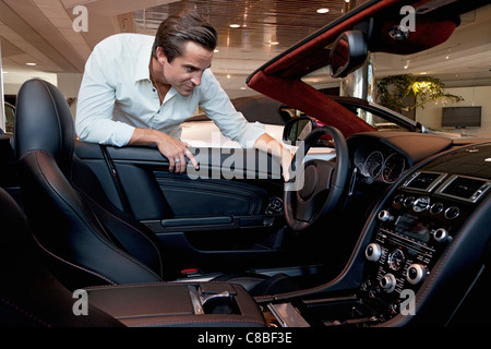 Man checking out his new car Stock Photo