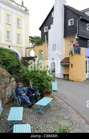 tourists sitting on a bench portmeirion gwynedd north wales uk Stock Photo