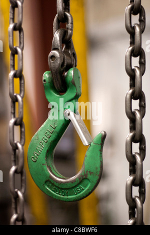 A hook at the end of a chain attached to a block and tackle. Stock Photo