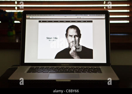 An image of the late Steve Jobs, founder and former CEO of Apple Inc., is displayed on the screen of an Apple Macbook Pro. Stock Photo