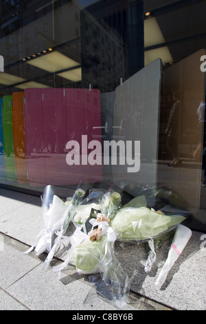 Flowers are left for the late Steve Jobs, founder and former CEO of Apple Inc., outside the Apple store in Ginza. Stock Photo