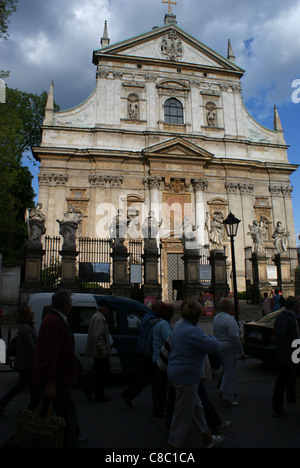 German tourists are looking at Saints Peter and Paul Church in Cracow, one of the most beautiful baroque elevation in the world. Stock Photo