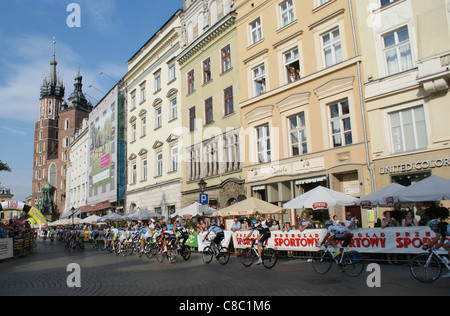 Cyclists riding in the Main Square of Old City in Cracow during last stage of Tour de Pologne 2011 race. Stock Photo