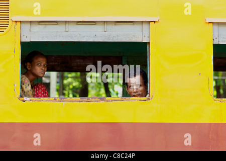 Passengers aboard a train in Yangon, Myanmar Stock Photo