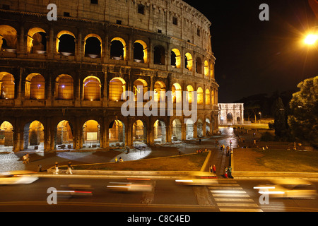Traffic passing the Colosseum in Rome, Italy. Stock Photo