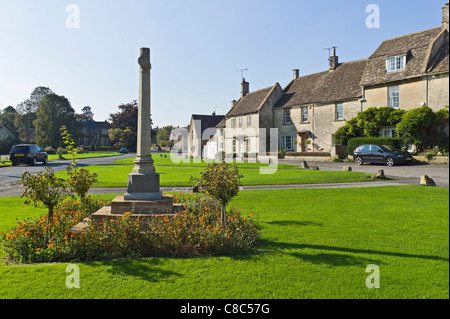 Village green and memorial cross in Biddestone Wiltshire UK Stock Photo