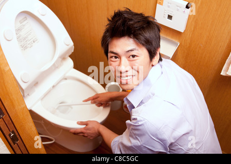 Man holding scrubbing brush Stock Photo: 5825989 - Alamy