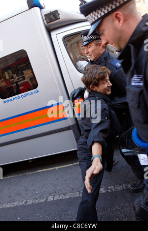 An Occupy London Stock Exchange protester clashes with police outside St Pauls Cathedral Stock Photo