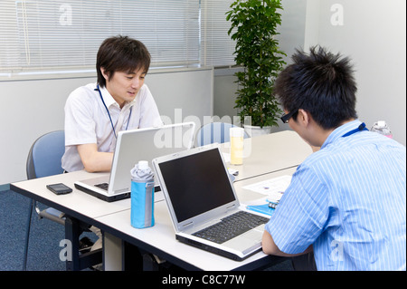 Two businessmen in business casual working at office Stock Photo
