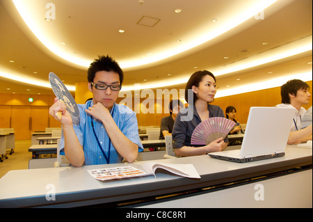 Businessmen and businesswomen sitting and listening presentation at hall Stock Photo