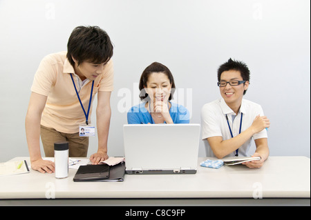 Boss and staffs having a meeting at desk Stock Photo