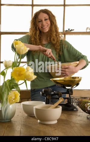 Woman mixing ingredients in kitchen Stock Photo