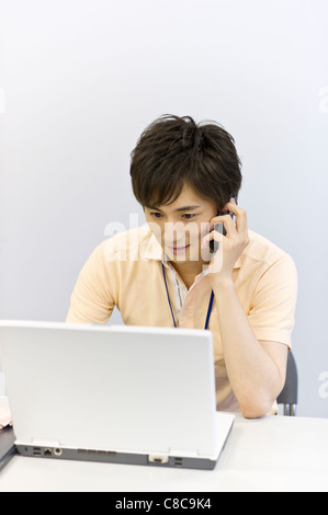 Young man in business casual talking on Smartphone Stock Photo