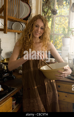 Woman mixing ingredients in kitchen Stock Photo