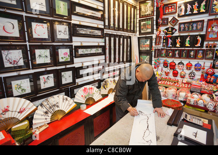 China, Beijing, The Silk Market, Artist Painting Stock Photo