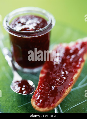 Raspberry jam on a slice of bread Stock Photo