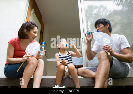 Family drinking soda at verandah Stock Photo