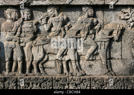 Stone Temple Relief Of Men On Horseback, Penataran Temple Java Stock Photo