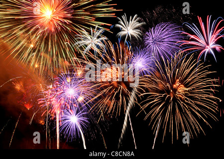 Fireworks of various colors bursting against a black background Stock Photo