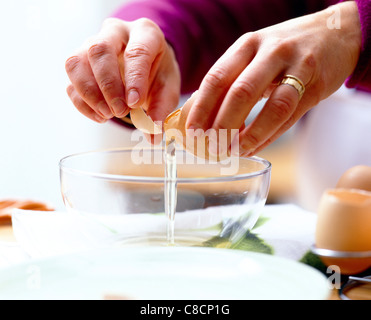 separating egg yolks and egg whites Stock Photo