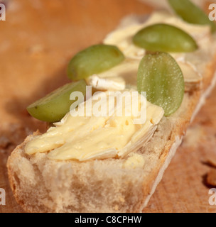 Brie and Grapes on a white baguette Stock Photo