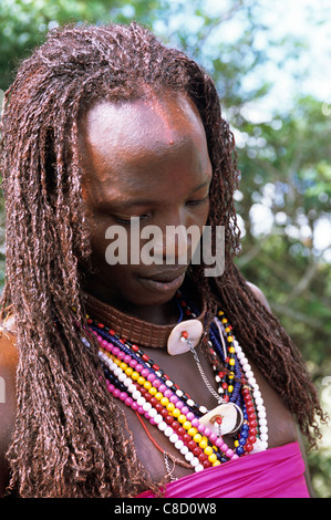 Lolgorian, Kenya. Siria Maasai Manyatta; Olelekule, moran, red ochre coloured braided hair, shell decoration. Stock Photo