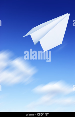 Paper plane flying. Sky and clouds in the background  Stock Photo
