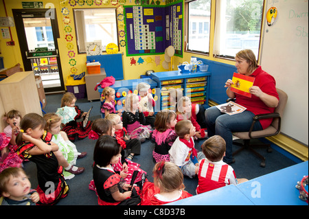 International Day - A woman teacher with children in class at a primary school talking about Spain, Wales UK Stock Photo