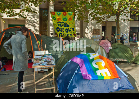 St Pauls, Occupy London, anti capitalist camp. 'Peace' and 'Grow your own future' banners above tents/  book stall. Stock Photo